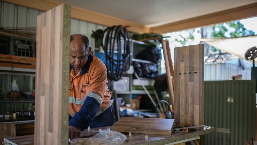 BHP employee Glenn Palman works in his shed in Leinster, WA.