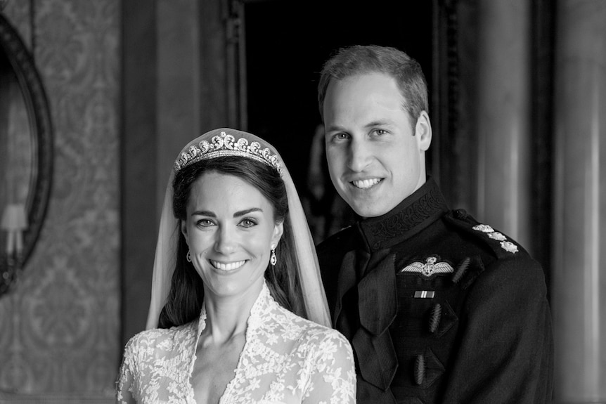 A black and white portrait of Prince William and Catherine on their wedding day.