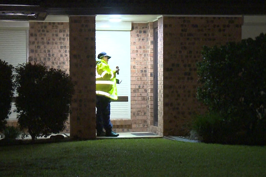 A policeman knocking on a door 