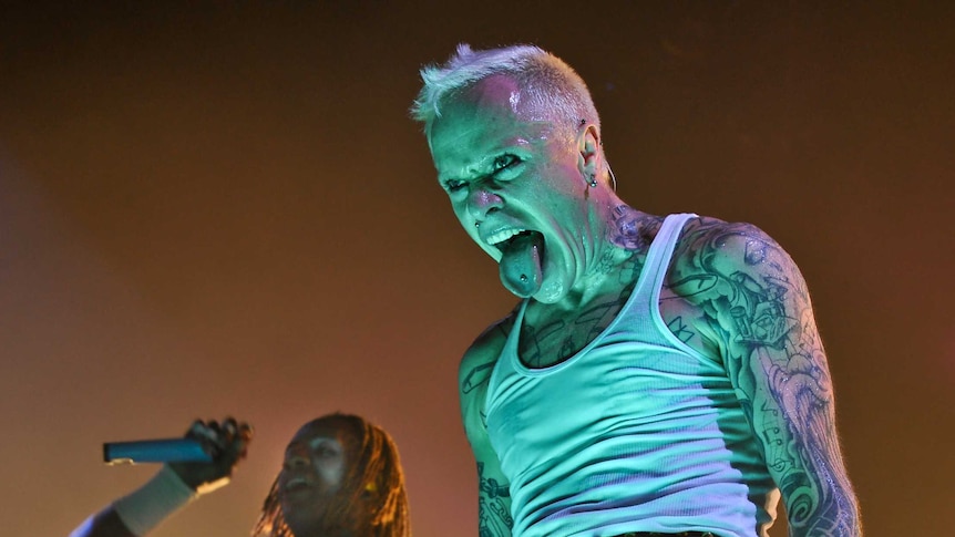 Keith Flint on stage sticking his tongue out