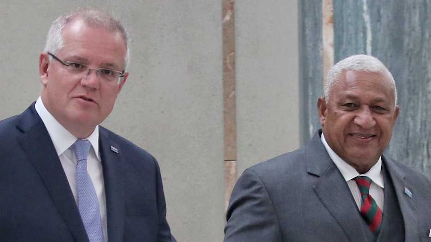 Australian Prime Minister Scott Morrison walks alongside Fijian Prime Minister Frank Bainimarama