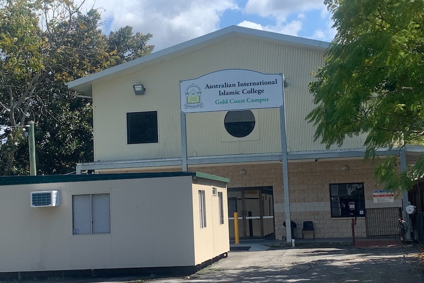 A school building surrounded by trees.