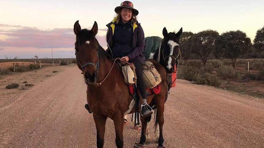Stef Gebbie sits on her horses, Tickles and Richard, on a dusty outback trail.