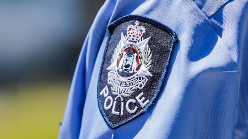 A WA Police badge on an officer's shirt shoulder.