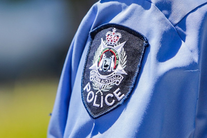 The WA Police insignia on the shoulder of an officer's shirt.