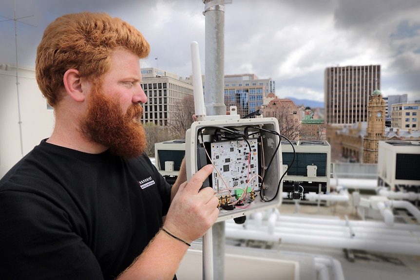 Worker sets up internet gateway in Hobart