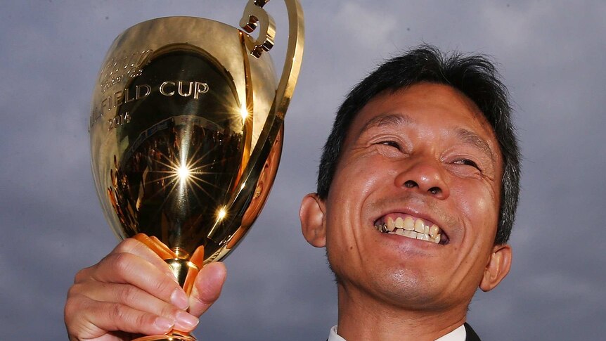 Admire Rakti trainer Tomoyuki Umeda with the Caulfield Cup trophy.