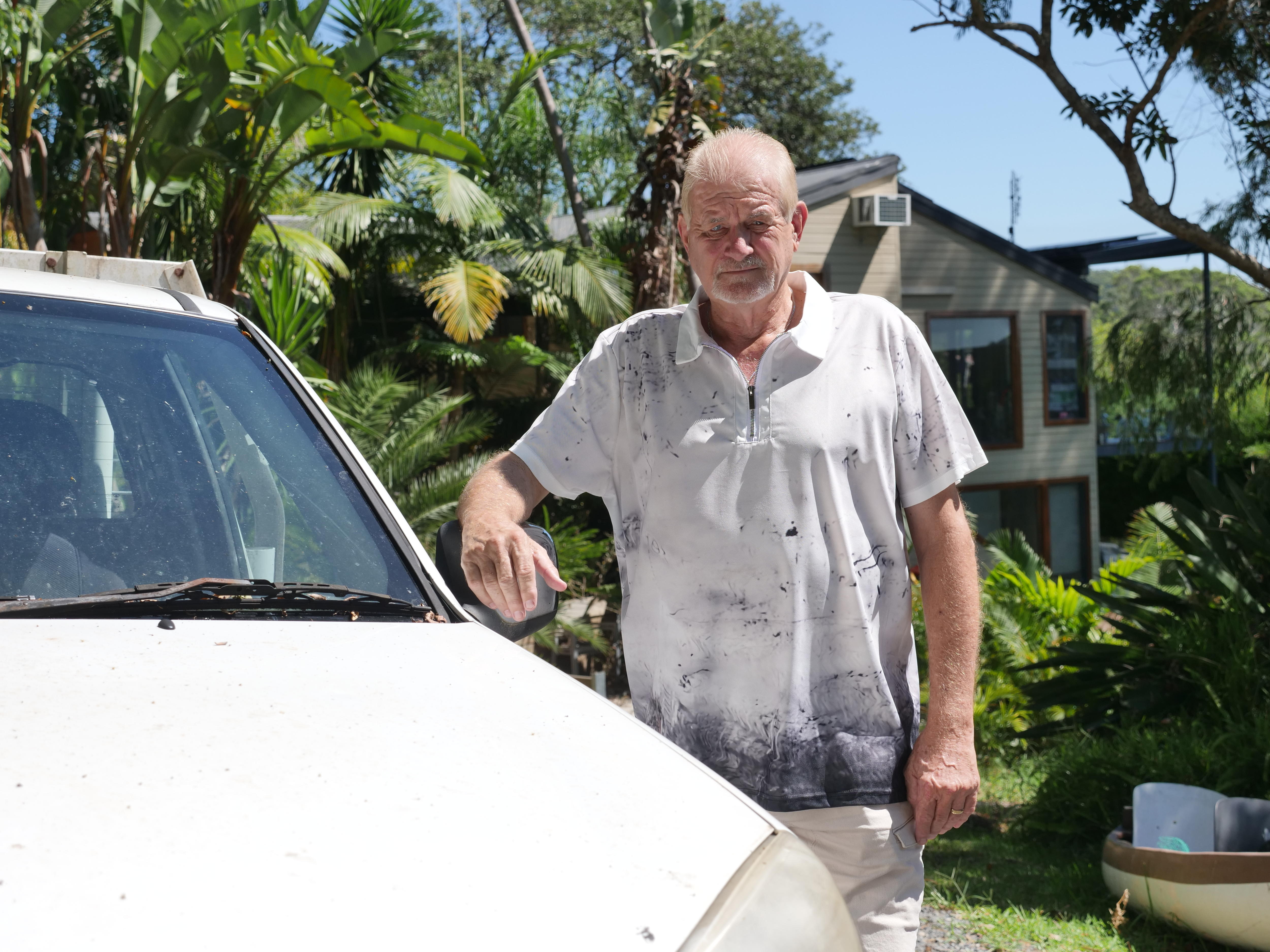 A man standing next to a car