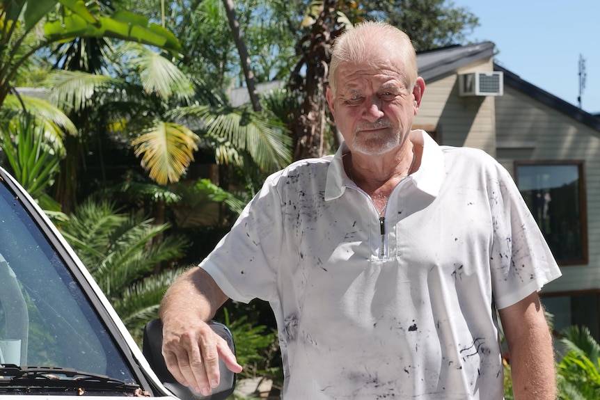 A man standing next to a car