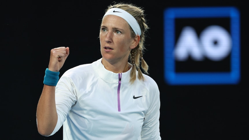 A Belarusian female tennis player pumps her fist at the Australian Open.