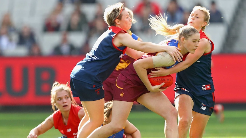Queensland's Tayla Harris is tackled by Melbourne's Jess Cameron in AFL women's game at MCG.