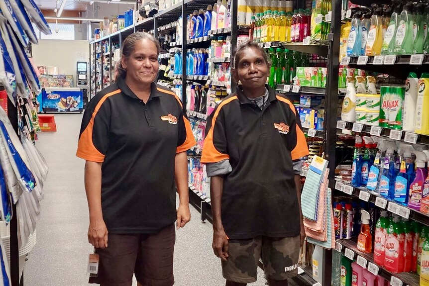 Two Indigenous women working at a grocery store smile at camera