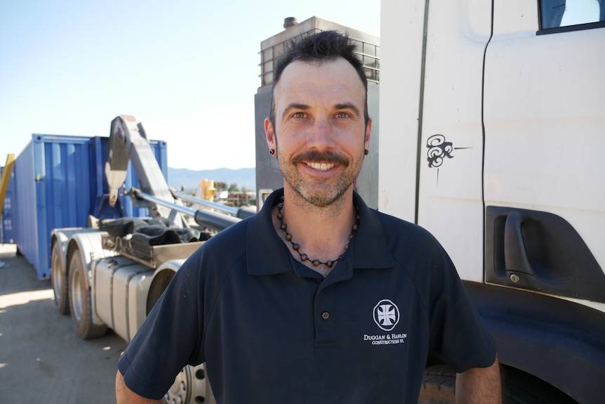 Lee Duggan standing in front of his truck.