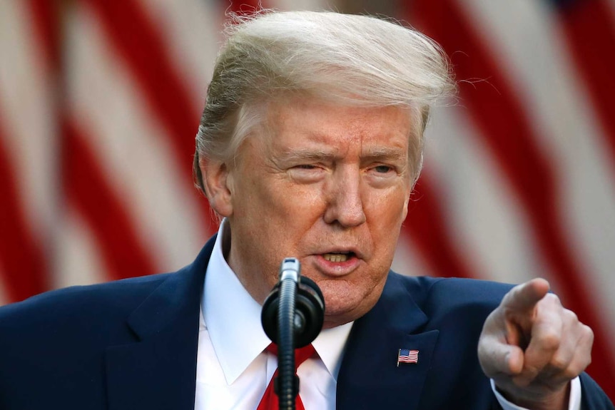 President Donald Trump points while speaking at a press conference at the White House