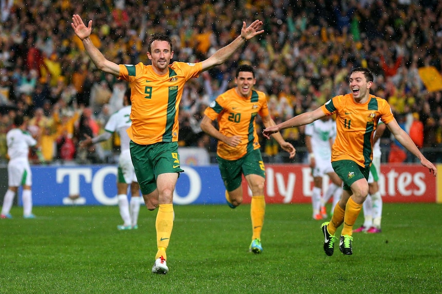 Brazil ticket booked ... Josh Kennedy celebrates his winning goal against Iraq.