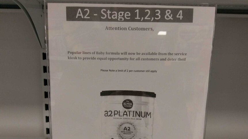 Sign stating baby formula will be sold behind the counter
