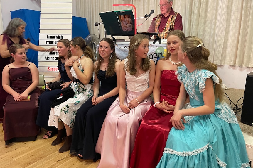 Photo of young girls dressed in ball gowns.