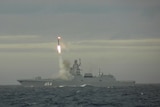 Missile launched from ship at sea.
