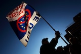A man waves a flag during a rally to protest against Croatia's EU membership