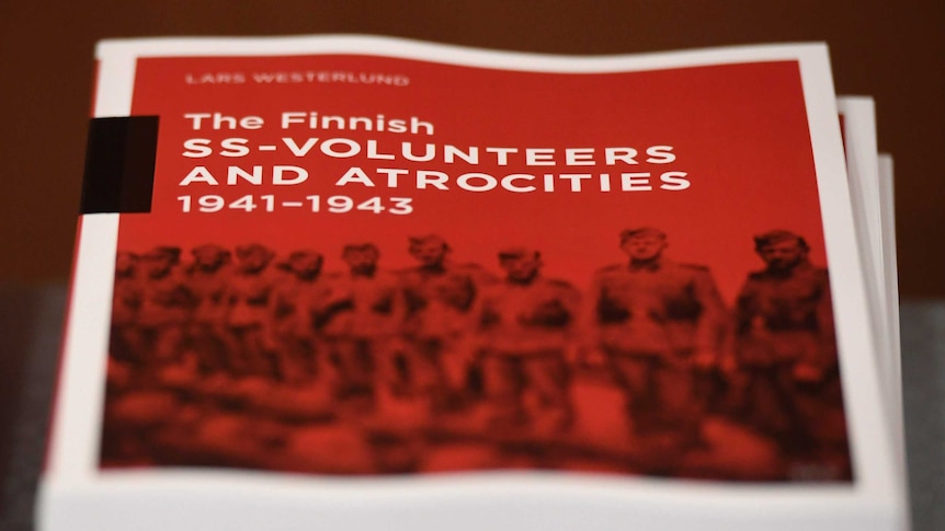 A close-up soft focus photo of a stack of bright red reports are on top of each other.