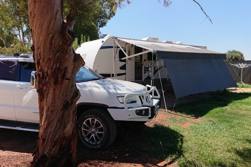 A 4WD sits next to a self-contained caravan at Mildura Caravan Park.
