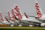 A row of Virgin Australia aircraft grounded at on airport after the company went into voluntary administration in April 2020.