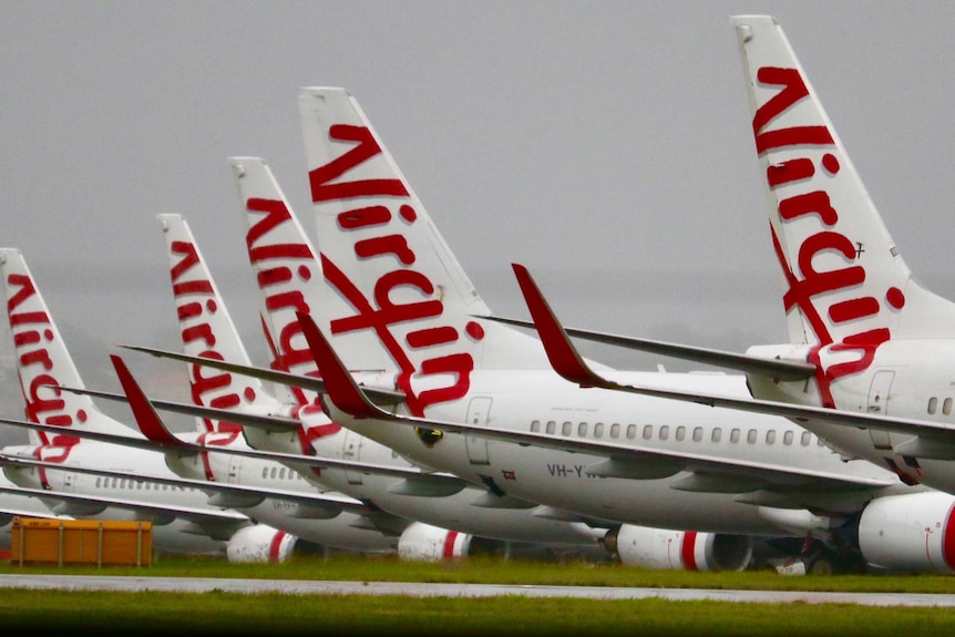 A row of Virgin Australia aircraft grounded at on airport after the company went into voluntary administration in April 2020.