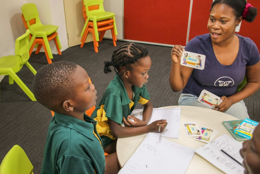 Teacher holding up card for children