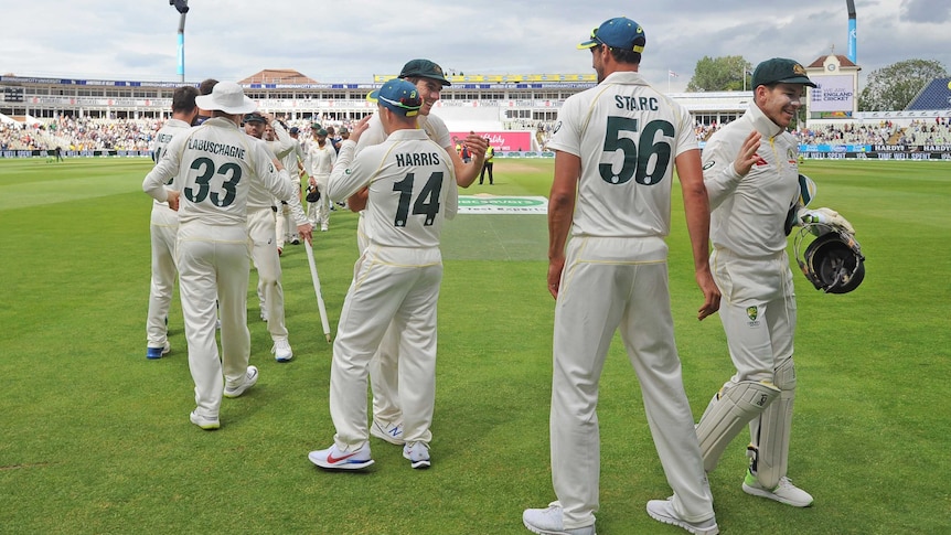 Players line up to give hugs and high fives as they celebrate an Ashes Test win.