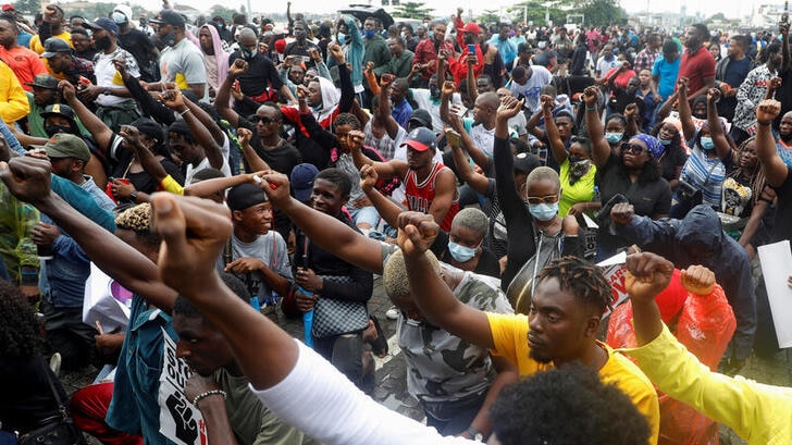 Demonstrators gesture during a protest over alleged police brutality, in Lagos, Niger