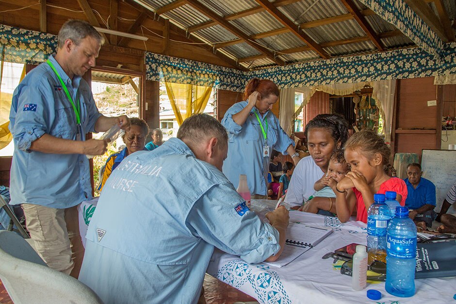 Aid workers fill out paperwork