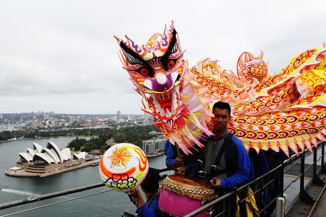 A 15-metre Chinese dragon dances up the eastern arch of the Harbour Bridge