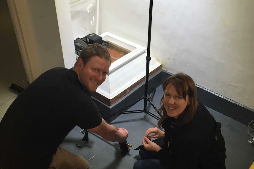 ABC cameraman Cameron Bauer and producer Donna Mountain with the well under Australia House.