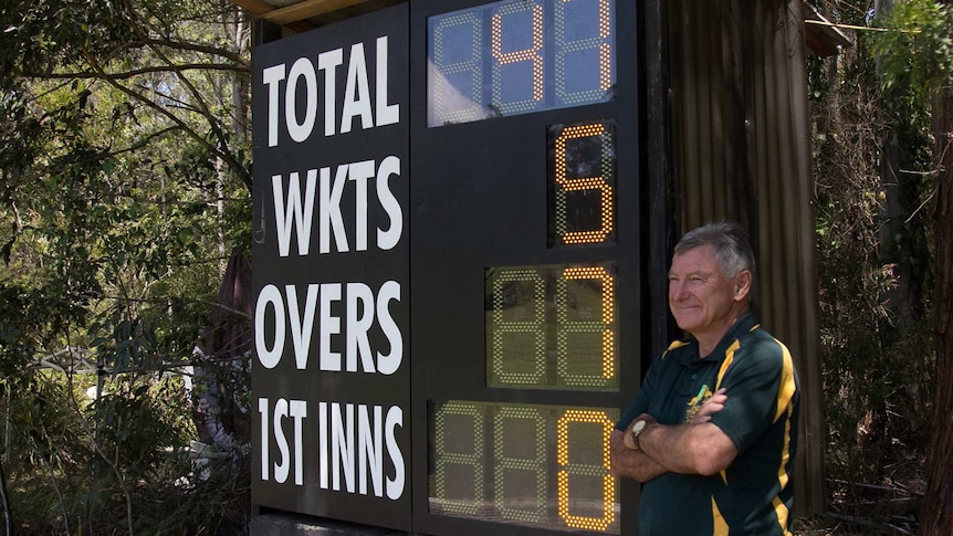 Stirling Hamman poses with the electronic scoreboard