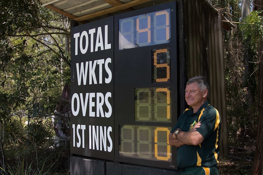 Stirling Hamman poses with the electronic scoreboard