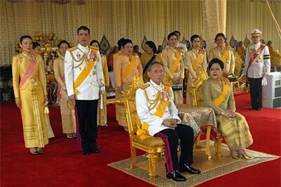 Thailand's King Bhumibol Adulyadej and Queen Sirikit sit infront of the Thai Royal family at the Royal Plaza on June 9, 2006 ...