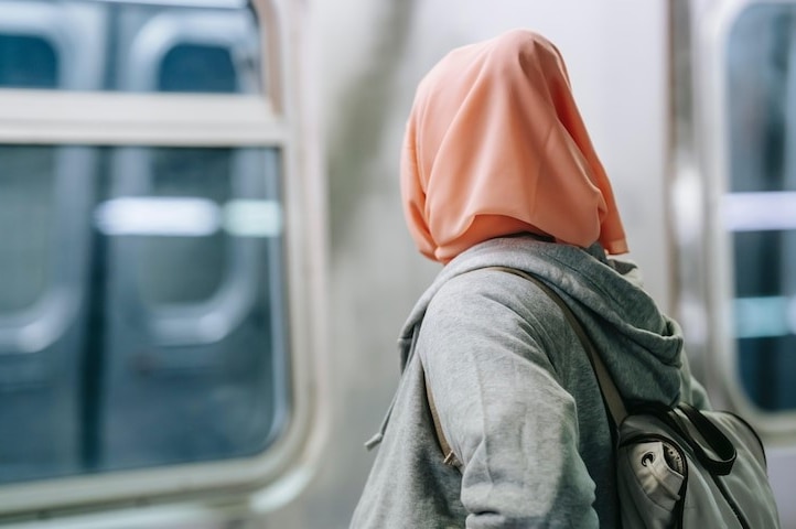 The back of a Muslim woman wearing a burqa.