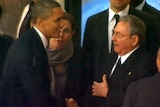 LtoR Barack Obama shakes hands with Raul Castro at the memorial service for Nelson Mandela.
