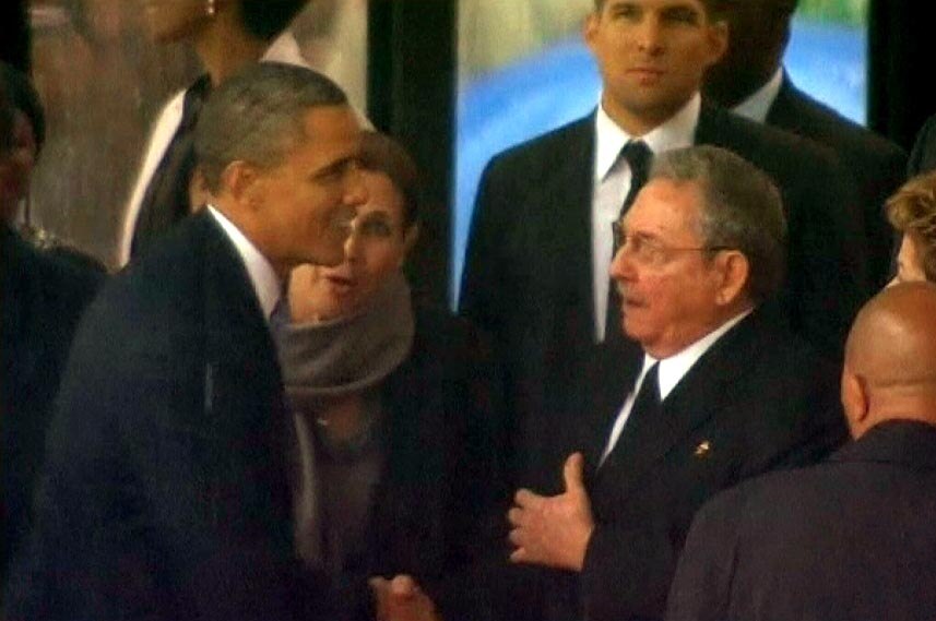 LtoR Barack Obama shakes hands with Raul Castro at the memorial service for Nelson Mandela.