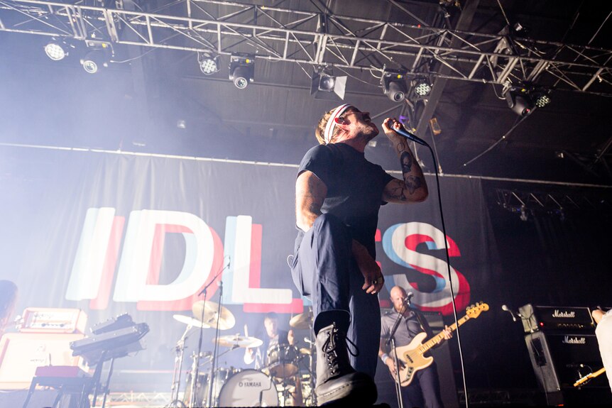 IDLES vocalist Joe Talbot screams to the sky onstage at Melbourne's Festival Hall
