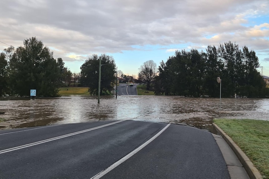 A road covered in murky floodwater.