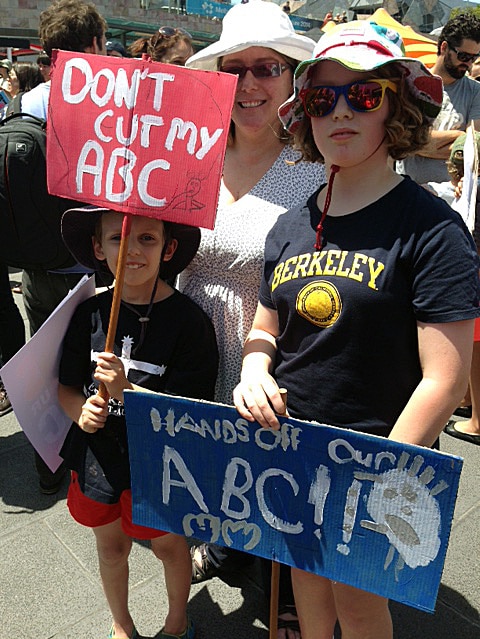 A family taking part in protests against ABC funding cuts