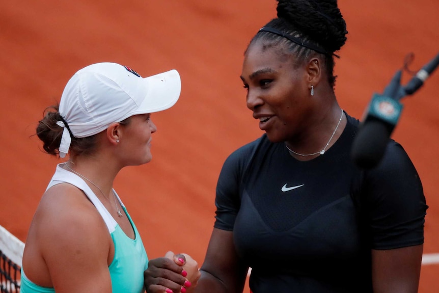 Serena Williams and Ashleigh Barty shake hands over the net at French Open