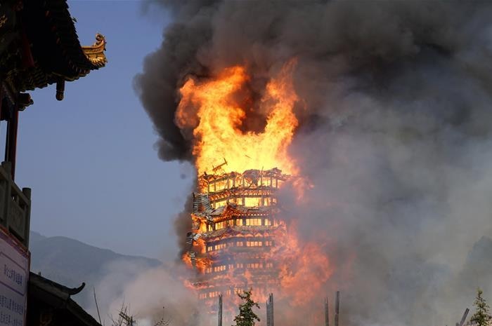 Fire takes out a 15-storey Pagoda in China's Sichuan province. The whole building appears to be on fire and there is black smoke