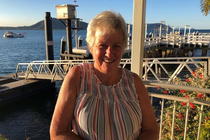 Woman smiling in front of wharf