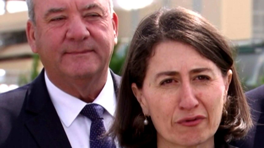 Daryl Maguire stands behind Gladys Berejiklian during a media conference.