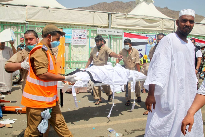 Saudi emergency personnel transport a body on a stretcher at the site where at least 450 were killed and hundreds wounded in a stampede in Mina Sep 2015