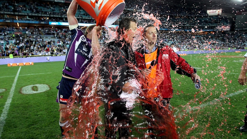 Craig Bellamy is drenched with Gatorade following the Storm's 14-4 NRL grand final win.