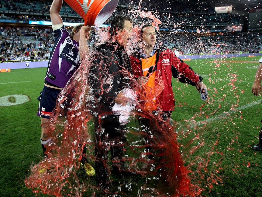 Craig Bellamy is drenched with Gatorade following the Storm's 14-4 NRL grand final win.