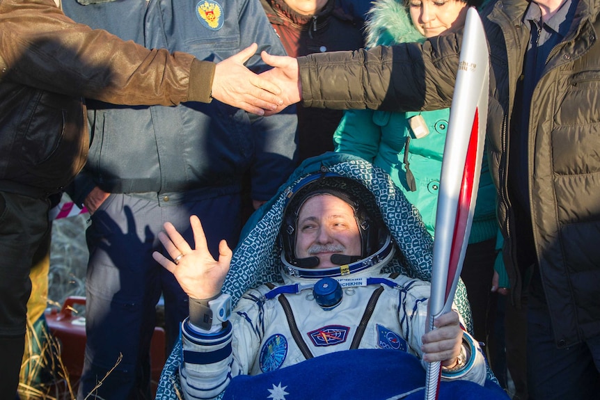 Russian cosmonaut Fyodor Yurchikhin holds the Sochi Olympic torch